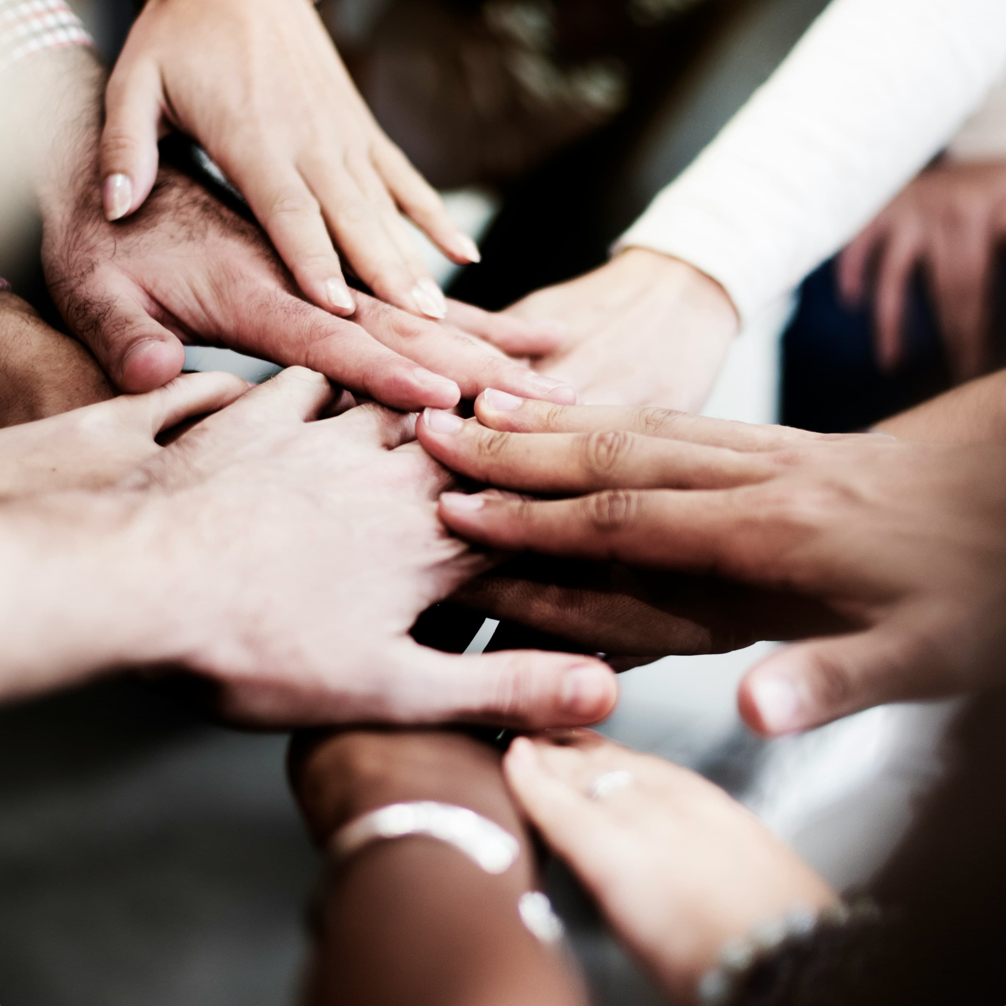Hands resting together in a group practice